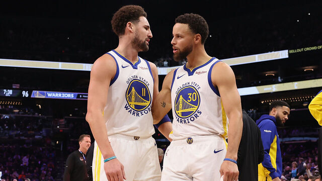 PHOENIX, ARIZONA - DECEMBER 12: Stephen Curry #30 of the Golden State Warriors talks with Klay Thompson #11during the NBA game at Footprint Center on December 12, 2023 in Phoenix, Arizona. The Suns defeated the Warriors 119-116.