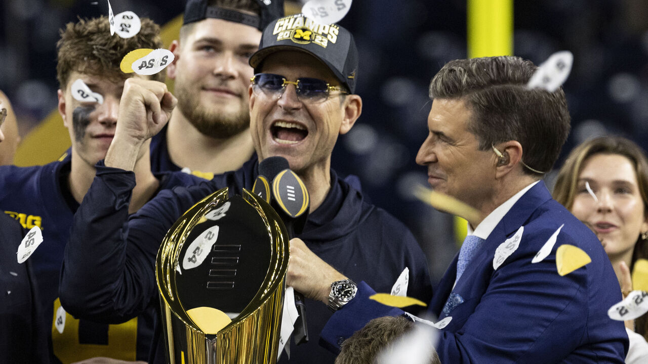 HOUSTON, TX - JANUARY 8: Head Coach Jim Harbaugh of the Michigan Wolverines is interviewed during the trophy presentation after the CFP National Championship game between University of Washington and University of Michigan at NRG Stadium on January 8, 2024 in Houston, Texas.