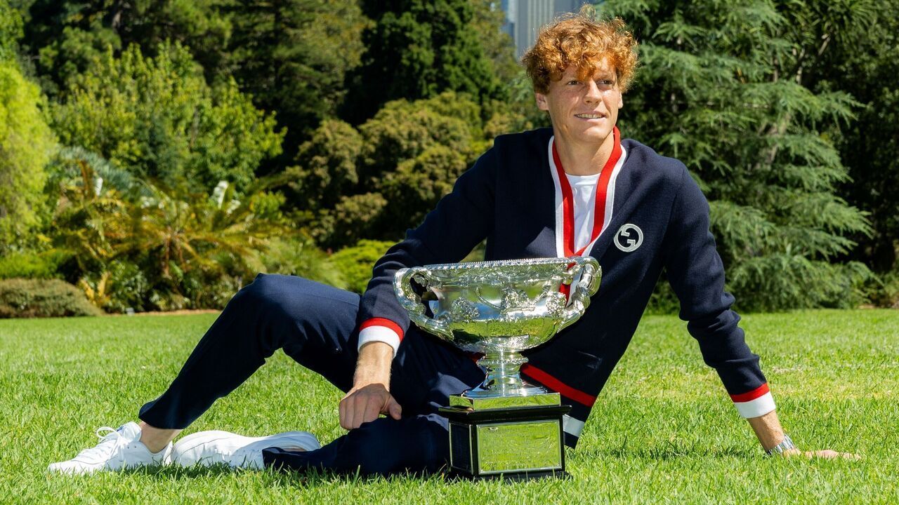 Jannik Sinner of Italy poses with the Australian Open trophy, the Norman Brookes Challenge Cup at the Royal Botanic Gardens Victoria in Melbourne, Australia, Jan. 29, 2024.
