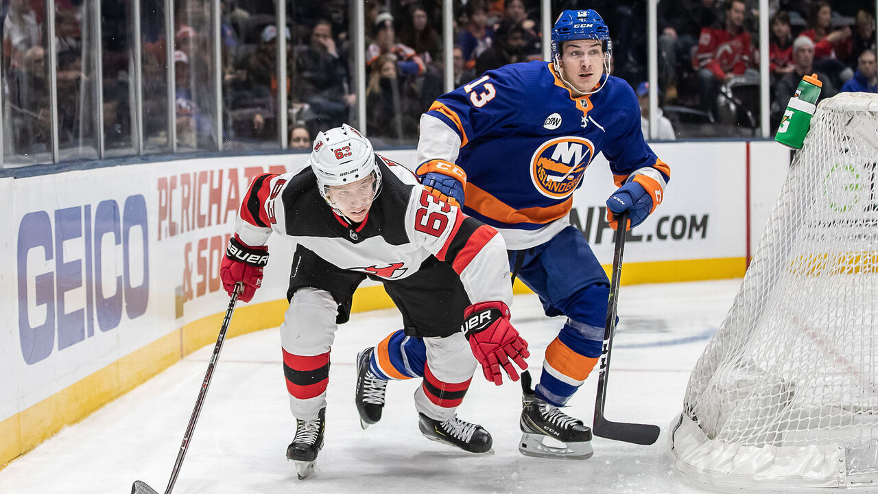UNIONDALE, NY - JANUARY 17: Mathew Barzal (13) of the New York Islanders and New Jersey Devils forward Jesper Bratt (63) look to get the advantage as they race for an open puck during a game between the New York Islanders and the New Jersey Devils on January 17, 2018 at the Nassau Veterans Memorials Coliseum / NYCB Live in Uniondale, NY.