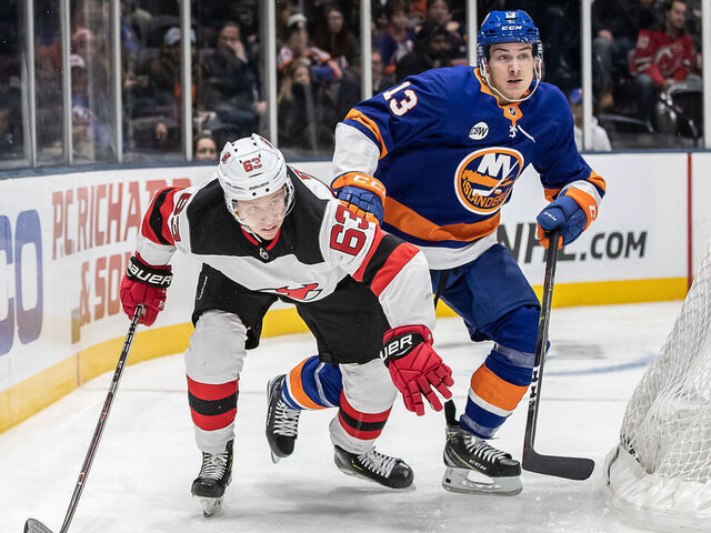 UNIONDALE, NY - JANUARY 17: Mathew Barzal (13) of the New York Islanders and New Jersey Devils forward Jesper Bratt (63) look to get the advantage as they race for an open puck during a game between the New York Islanders and the New Jersey Devils on January 17, 2018 at the Nassau Veterans Memorials Coliseum / NYCB Live in Uniondale, NY.