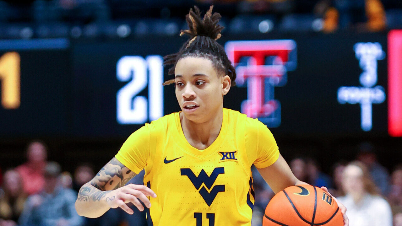 MORGANTOWN, WV - JANUARY 21: West Virginia Mountaineers guard JJ Quinerly (11) with the basketball during the third quarter of the women's college basketball game between the Texas Tech Red Raiders and West Virginia Mountaineers on January 21, 2023, at the WVU Coliseum in Morgantown, WV.