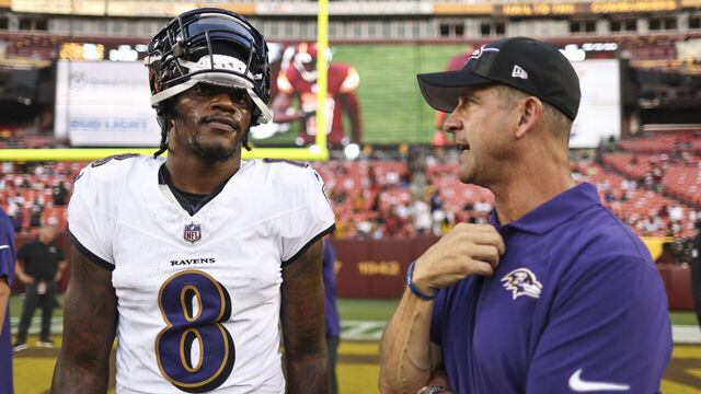 LANDOVER, MARYLAND - AUGUST 21: Lamar Jackson #8 of the Baltimore Ravens chats with head coach John Harbaugh of the Baltimore Ravens during an NFL preseason game at FedExField on August 21, 2023 in Landover, Maryland.