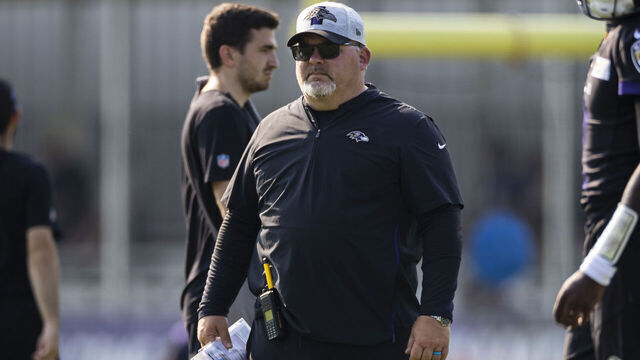 OWINGS MILLS, MD - JULY 28: Offensive coordinator Greg Roman of the Baltimore Ravens watches play during training camp at Under Armour Performance Center Baltimore Ravens on July 28, 2021 in Owings Mills, Maryland.