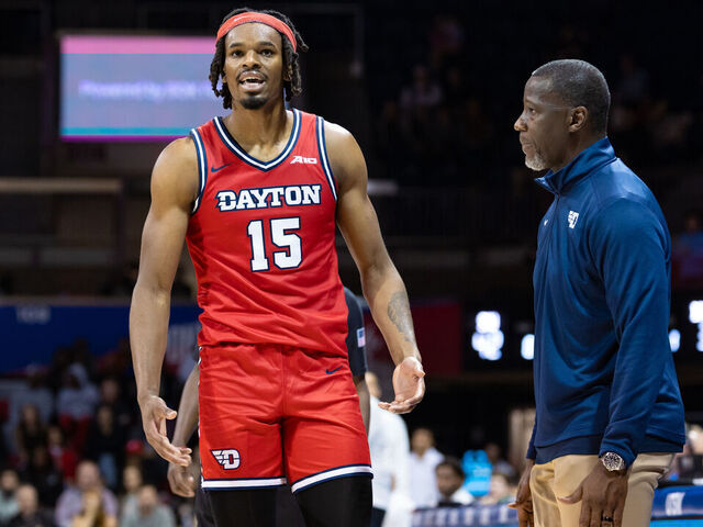 DALLAS, TX - NOVEMBER 29: Dayton Flyers forward DaRon Holmes II (#150 talks to head coach Anthony Grant during the college basketball game between the SMU Mustangs and the Dayton Flyers on November 29, 2023 at Moody Colseum in Dallas, Texas.