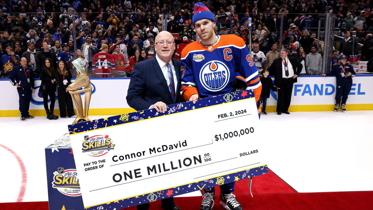 TORONTO, ONTARIO - FEBRUARY 02: Deputy NHL Commissioner Bill Daly presents Connor McDavid #97 of the Edmonton Oilers with a one million dollar check for winning the 2024 NHL All-Star Skills Competition at Scotiabank Arena on February 02, 2024 in Toronto, Ontario, Canada.