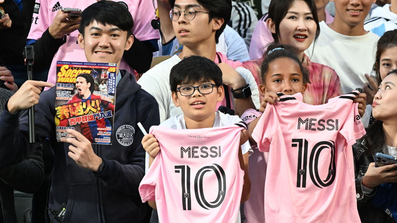 Fans cheer for Inter Miami's Argentine forward Lionel Messi during training for the friendly football match between Hong Kong Team and US Inter Miami CF at the Hong Kong Stadium in Hong Kong on February 3, 2024.