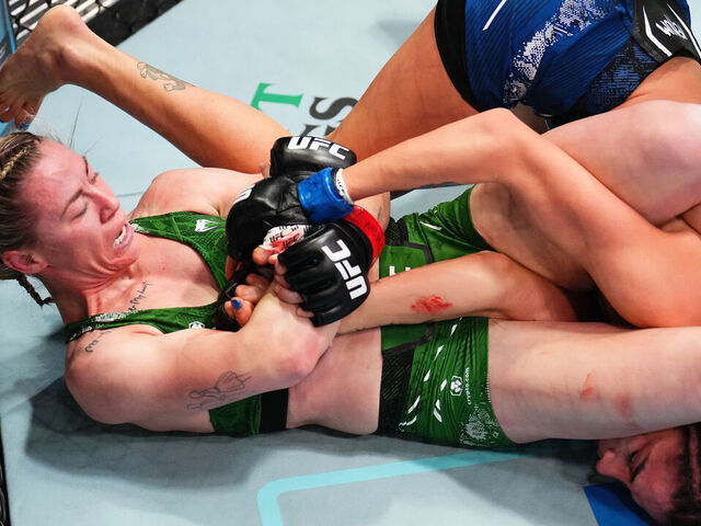 LAS VEGAS, NEVADA - FEBRUARY 03: (L-R) Molly McCann of England secures an arm bar submission against Diana Belbita of Romania in a strawweight fight during the UFC Fight Night event at UFC APEX on February 03, 2024 in Las Vegas, Nevada.