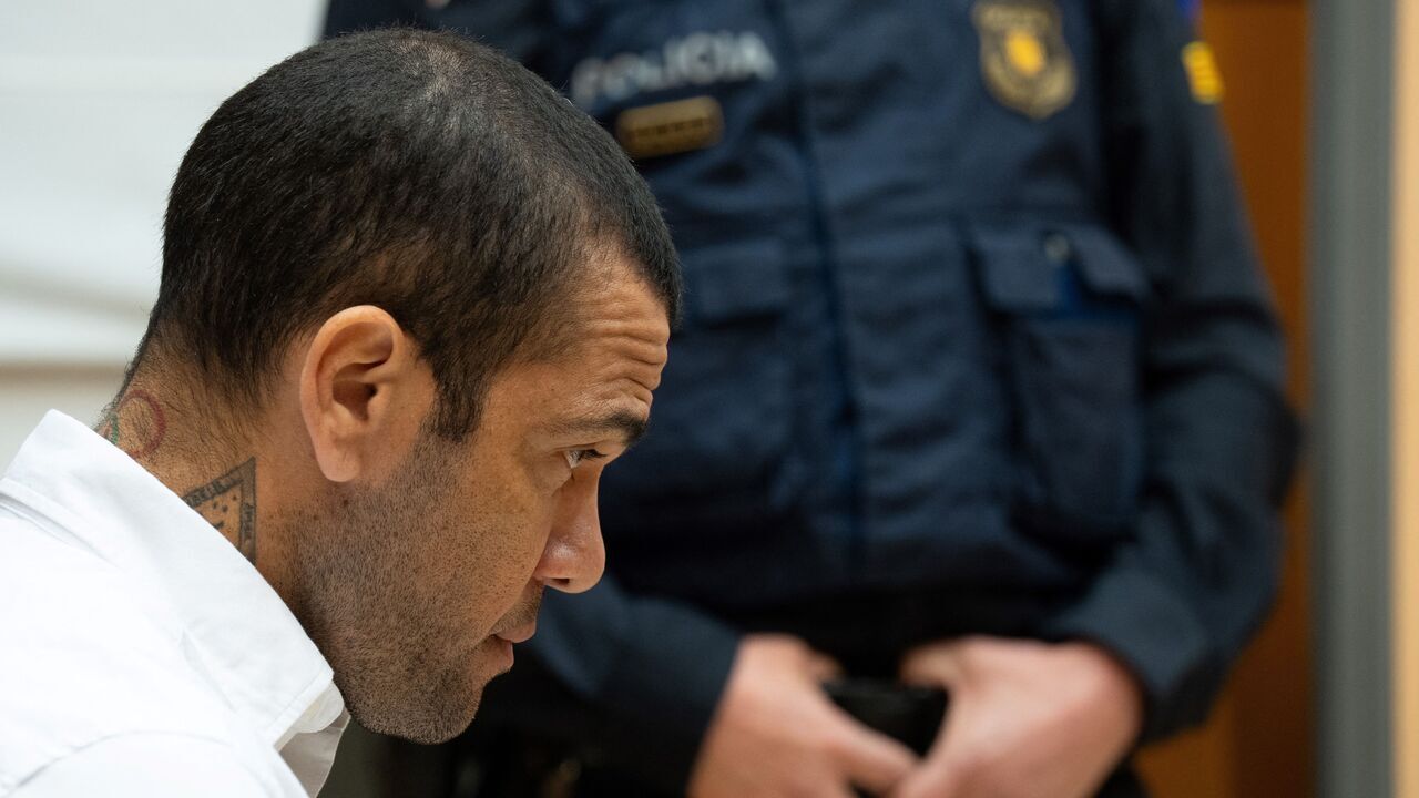Brazilian footballer Dani Alves looks on at the start of his trial at the High Court of Justice of Catalonia in Barcelona, on February 5, 2024. Brazilian footballer Dani Alves, a former star at Barca and PSG, goes on trial in Barcelona accused of raping a woman in a local nightclub. Prosecutors are asking for a nine-year prison sentence, followed by 10 years of conditional liberty. They are also asking he pay 150,000 euros ($162,000) in compensation to the woman.