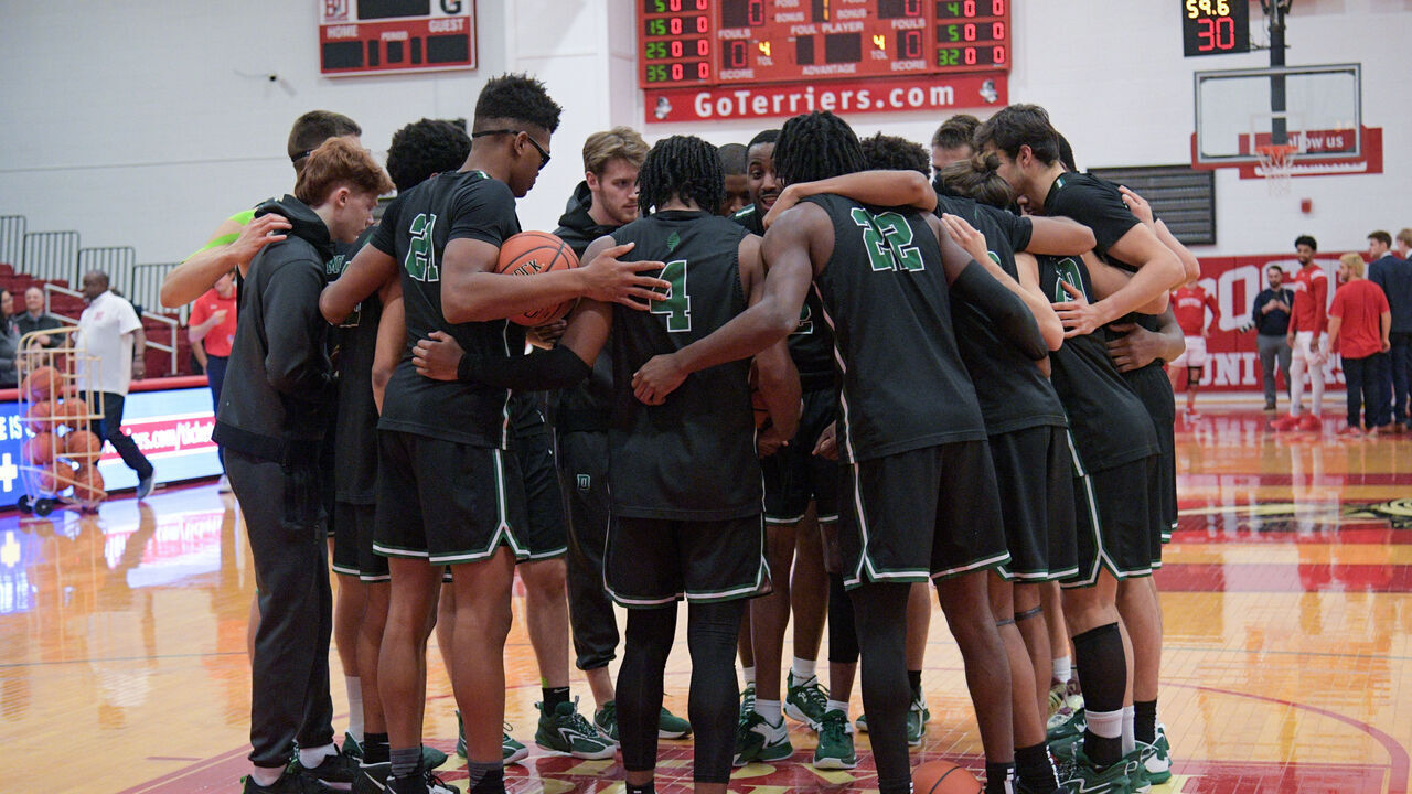 BOSTON, MA - DECEMBER 13: Dartmouth Big Green players huddle on the court prior to a college basketball game between the Dartmouth Big Green and the Boston University Terriers on December 13, 2022, at Case Gym in Boston, MA.