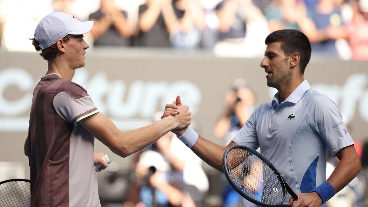 MELBOURNE, AUSTRALIA - JANUARY 26: Jannik Sinner of Italy shakes hands with Novak Djokovic of Serbia in their Semifinal singles match during the 2024 Australian Open at Melbourne Park on January 26, 2024 in Melbourne, Australia.