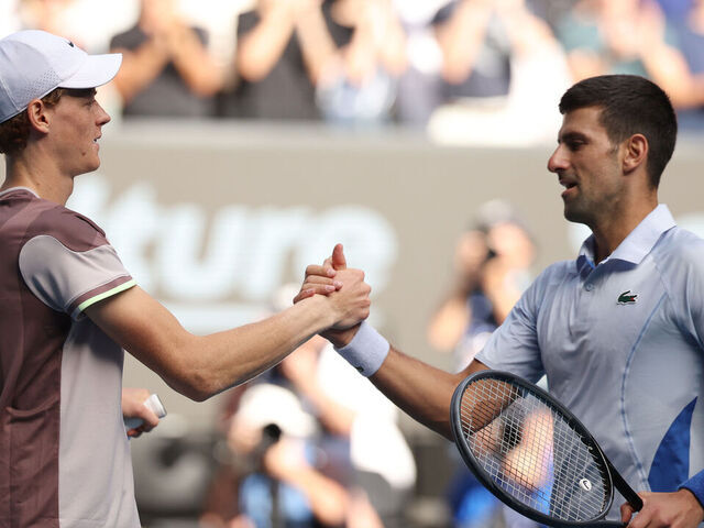 MELBOURNE, AUSTRALIA - JANUARY 26: Jannik Sinner of Italy shakes hands with Novak Djokovic of Serbia in their Semifinal singles match during the 2024 Australian Open at Melbourne Park on January 26, 2024 in Melbourne, Australia.