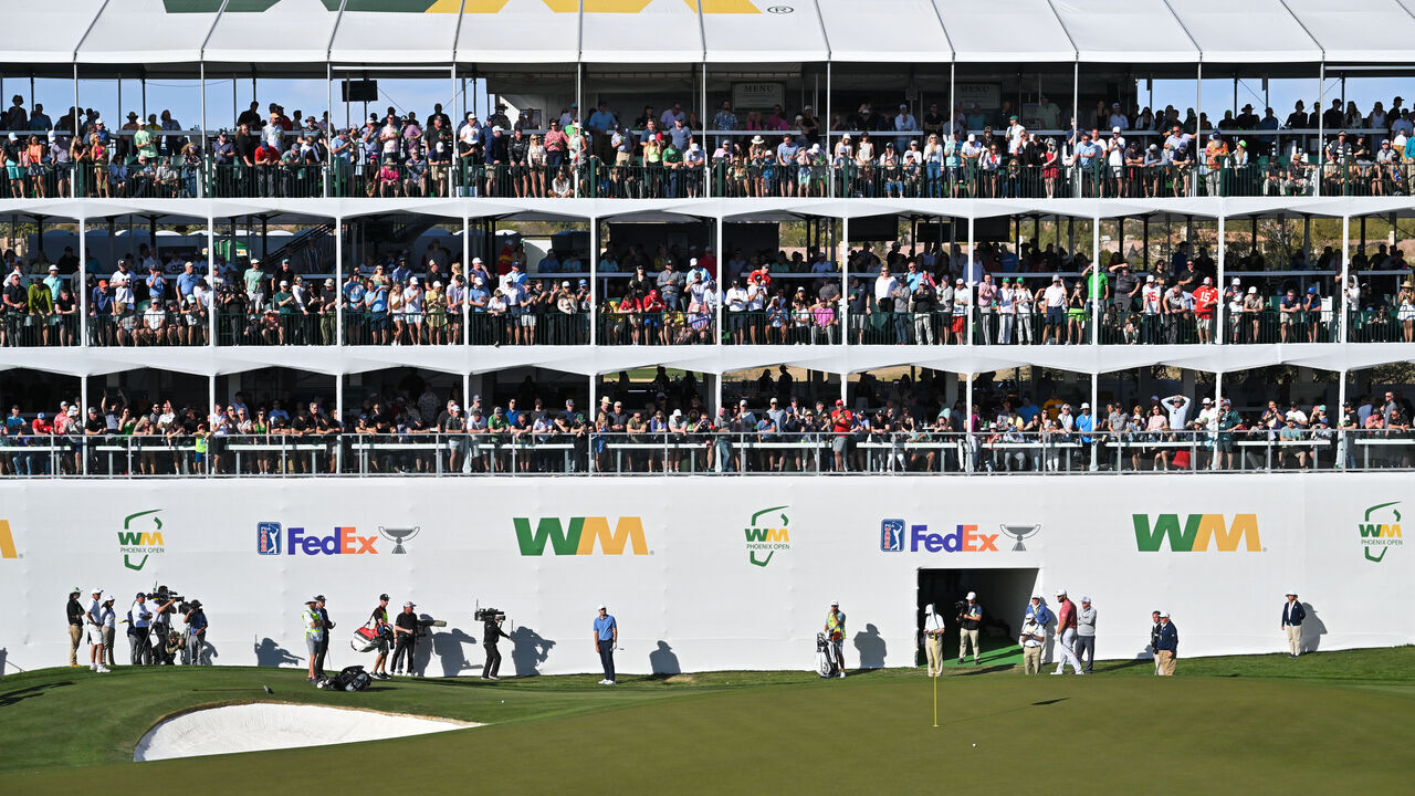SCOTTSDALE, ARIZONA - FEBRUARY 12: Scottie Scheffler hits a shot onto the 16th green during the final round of the WM Phoenix Open at TPC Scottsdale on February 12, 2023 in Scottsdale, Arizona.
