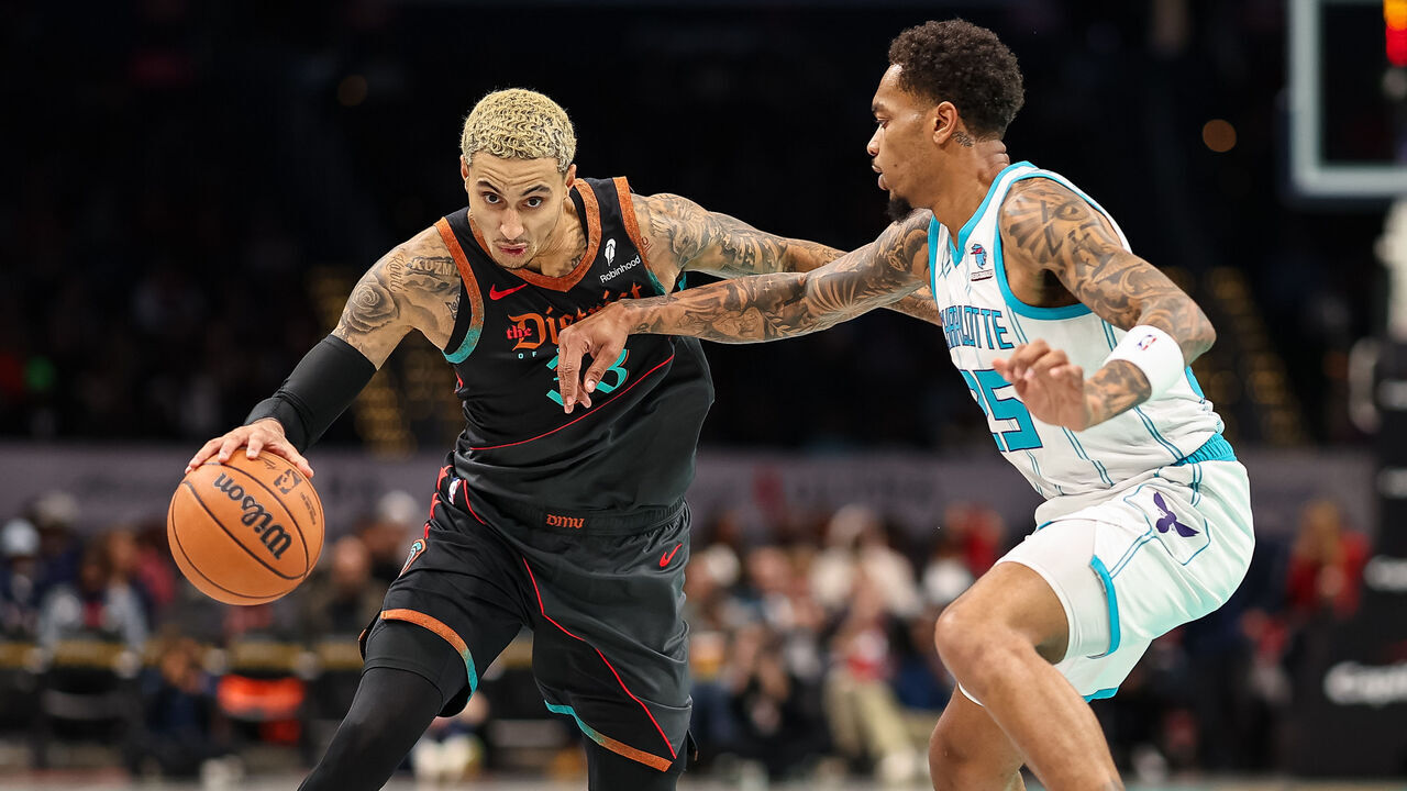 WASHINGTON, DC - NOVEMBER 10: Kyle Kuzma #33 of the Washington Wizards drives to the basket against P.J. Washington #25 of the Charlotte Hornets during the first half at Capital One Arena on November 10, 2023 in Washington, DC.