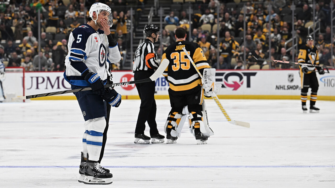 PITTSBURGH, PENNSYLVANIA - FEBRUARY 6: Brenden Dillon #5 of the Winnipeg Jets is lead off the ice after receiving a match penalty for boarding in the second period during the game against the Pittsburgh Penguins at PPG PAINTS Arena on February 6, 2024 in Pittsburgh, Pennsylvania.
