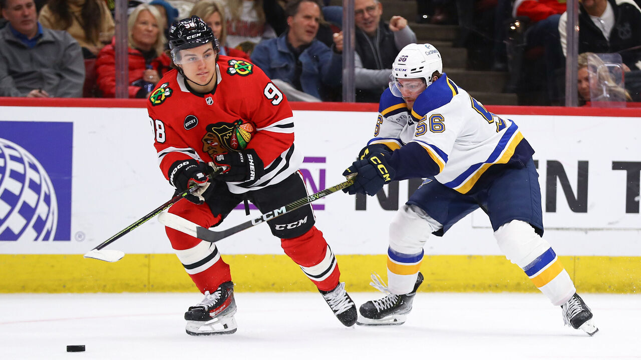 CHICAGO, IL - DECEMBER 09: Hugh McGing #56 of the St. Louis Blues and Connor Bedard #98 of the Chicago Blackhawks in action during the first period at the United Center on December 9, 2023 in Chicago, Illinois.