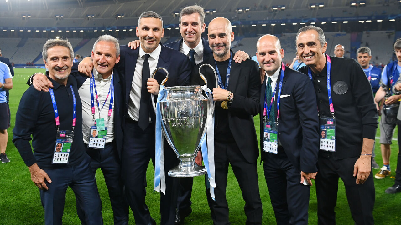 ISTANBUL, TURKEY - JUNE 10: City Football Group director of football Joan Patsy, Manchester City director of football Txiki Begiristain, Manchester City Chairman Khaldoon Al Mubarak, Manchester City CEO Ferran Soriano, Manchester City manager PepGuardiola, Pere Guardiola and Manchester City coach Manel Astiarte pose with the trophy after the UEFA Champions League 2022/23 final match between FC Internazionale and Manchester City FC at Ataturk Olympic Stadium on June 10, 2023 in Istanbul, Turkey.