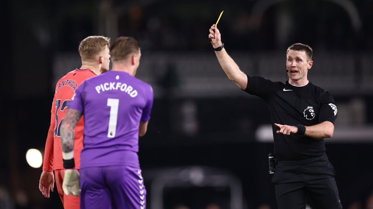 LONDON, ENGLAND - JANUARY 30: Referee Thomas Bramall shows a yellow card to Jarrad Branthwaite of Everton during the Premier League match between Fulham FC and Everton FC at Craven Cottage on January 30, 2024 in London, England.