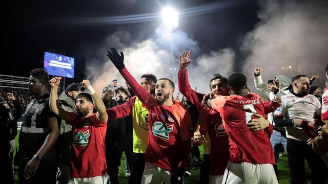 Rouen's players celebrate after winning the French Cup last sixteen football match between FC Rouen 1899 and AS Monaco at the Robert-Diochon Stadium in Petit-Quevilly, western France, on February 8, 2024.