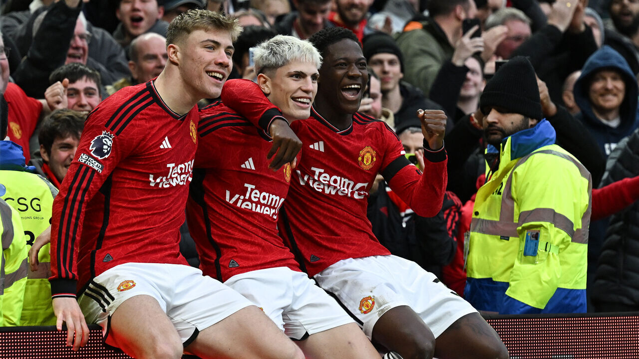 Manchester United's Argentinian midfielder #17 Alejandro Garnacho (C) celebrates after scoring his team second goal with Manchester United's Danish striker #11 Rasmus Hojlund (L) and Manchester United's English midfielder #37 Kobbie Mainoo during the English Premier League football match between Manchester United and West Ham United at Old Trafford in Manchester, north west England, on February 4, 2024.