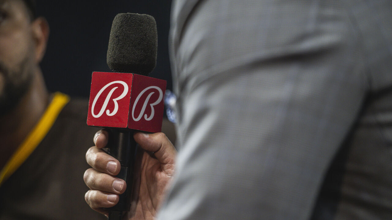 MIAMI, FL - MAY 30: The Bally Sports San Diego broadcaster holds up the microphone during the post game interview after the San Diego Padres defeated the Miami Marlins at loanDepot park on May 30, 2023 in Miami, Florida.