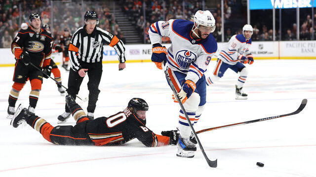 ANAHEIM, CALIFORNIA - FEBRUARY 09: Evander Kane #91 of the Edmonton Oilers skates past Jackson LaCombe #60 of the Anaheim Ducks and scores an empty net goal during the third period of a game at Honda Center on February 09, 2024 in Anaheim, California.