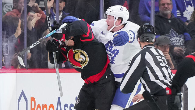 OTTAWA, CANADA - FEBRUARY 10: Morgan Rielly #44 of the Toronto Maple Leafs cross checks Ridly Greig #71 of the Ottawa Senators in the head after his empty net goal in the third period at Canadian Tire Centre on February 10, 2024 in Ottawa, Ontario, Canada.