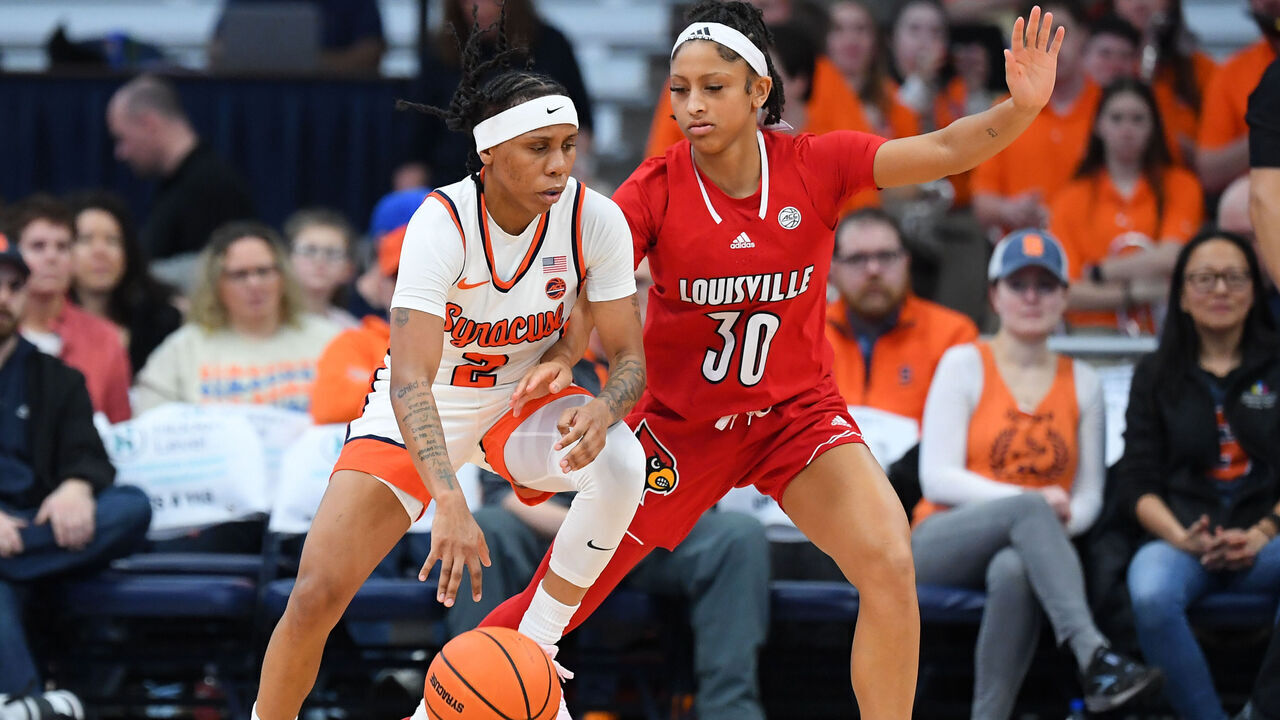 SYRACUSE, NEW YORK - FEBRUARY 11: Dyaisha Fair #2 of the Syracuse Orange drives to the basket as Jayda Curry #30 of the Louisville Cardinals defends during the second half at JMA Wireless Dome on February 11, 2024 in Syracuse, New York. Syracuse won 73-72.