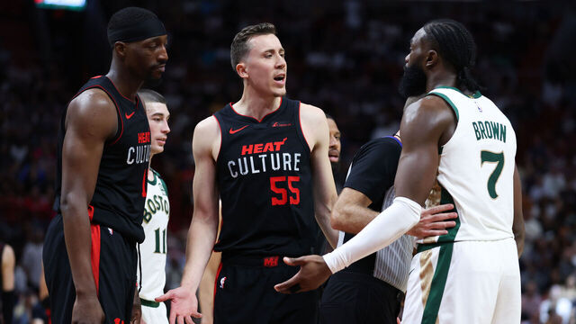 MIAMI, FLORIDA - FEBRUARY 11: Duncan Robinson #55 of the Miami Heat and Jaylen Brown #7 of the Boston Celtics exchange words on the court during the fourth quarter of the game at Kaseya Center on February 11, 2024 in Miami, Florida.