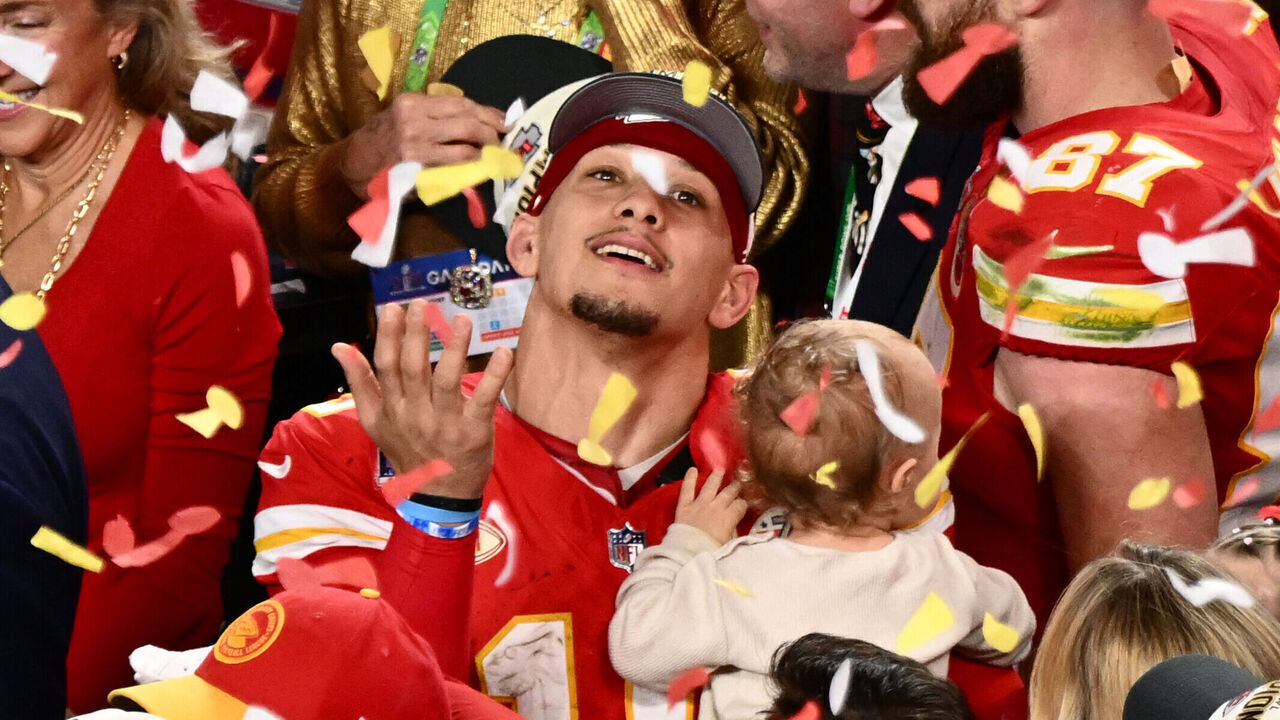 Kansas City Chiefs' quarterback #15 Patrick Mahomes with his son Patrick Bronze watches confettis as they celebrate winning Super Bowl LVIII against the San Francisco 49ers at Allegiant Stadium in Las Vegas, Nevada, February 11, 2024.
