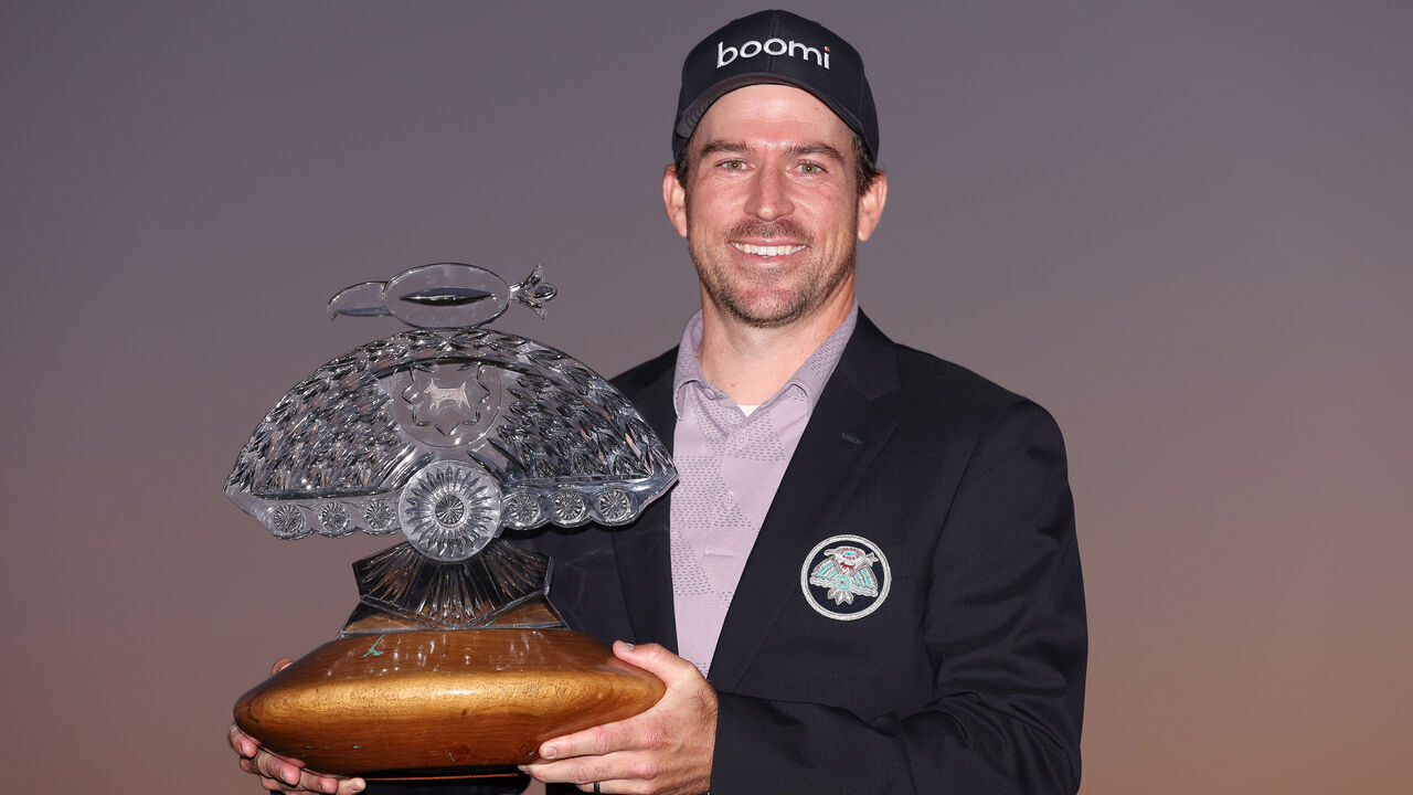 SCOTTSDALE, ARIZONA - FEBRUARY 11: Nick Taylor of Canada celebrates with the trophy after winning in a two-hole playoff during the final round of the WM Phoenix Open at TPC Scottsdale on February 11, 2024 in Scottsdale, Arizona.