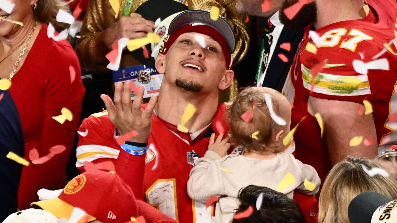 Kansas City Chiefs' quarterback #15 Patrick Mahomes with his son Patrick Bronze watches confettis as they celebrate winning Super Bowl LVIII against the San Francisco 49ers at Allegiant Stadium in Las Vegas, Nevada, February 11, 2024.