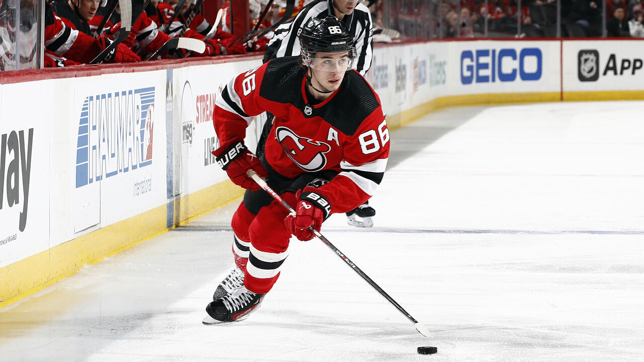 NEWARK, NEW JERSEY - FEBRUARY 08: Jack Hughes #86 of the New Jersey Devils controls the puck during the second period against the Calgary Flames at Prudential Center on February 08, 2024 in Newark, New Jersey.