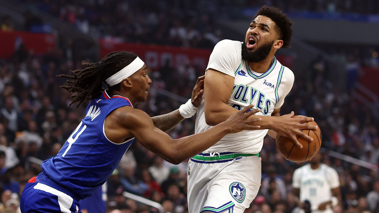 LOS ANGELES, CALIFORNIA - FEBRUARY 12: Karl-Anthony Towns #32 of the Minnesota Timberwolves drives to the basket against Terance Mann #14 of the Los Angeles Clippers during the first quarter at Crypto.com Arena on February 12, 2024 in Los Angeles, California.