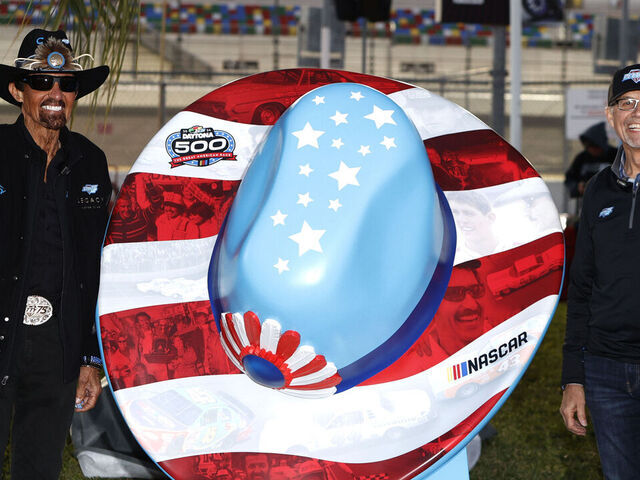 DAYTONA, FL - FEBRUARY 14: 7 time NASCAR Cup Series Champion Richard Petty and his son Kyle Petty pose for pictures after unvieling a statue honoring the Petty family for 75 years in racing prior to qualifying for the Daytona 500 on February 14, 2024 at Daytona International Speedway in Daytona Beach, FL.