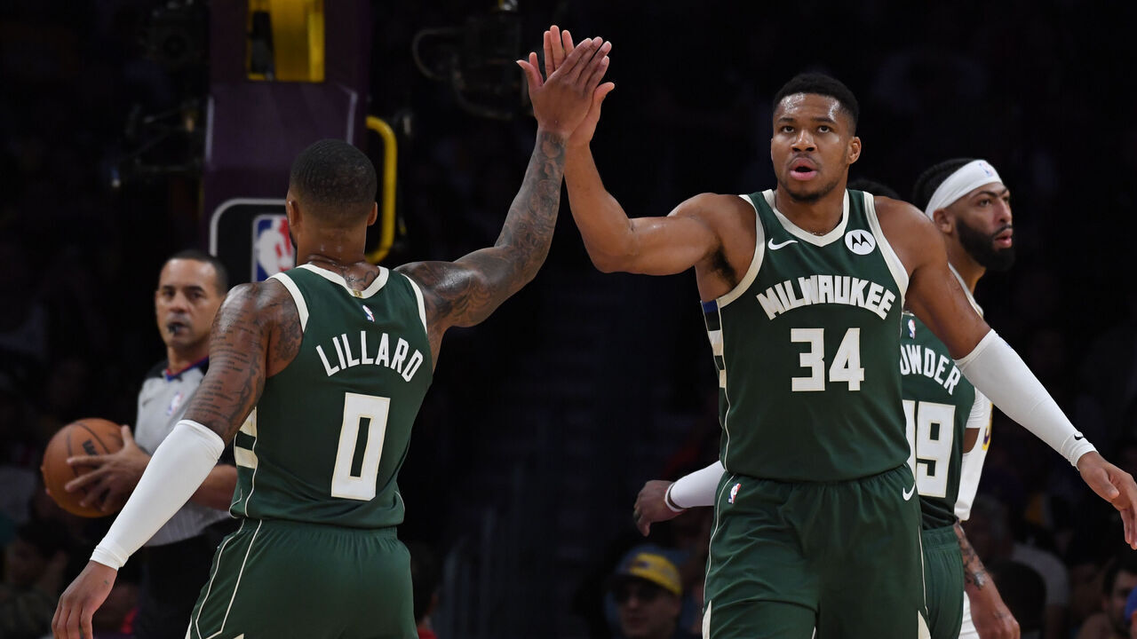LOS ANGELES, CA - OCTOBER 15: Damian Lillard #0 high fives Giannis Antetokounmpo #34 of the Milwaukee Bucks during the preseason game on October 15, 2023 at Crypto.Com Arena in Los Angeles, California. NOTE TO USER: User expressly acknowledges and agrees that, by downloading and/or using this Photograph, user is consenting to the terms and conditions of the Getty Images License Agreement. Mandatory Copyright Notice: Copyright 2023 NBAE