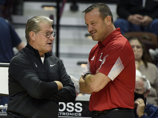UNCASVILLE, CONNECTICUT - DECEMBER 19: Head coach Geno Auriemma of the Connecticut Huskies talks with head coach Jeff Walz of the Louisville Cardinals before the Basketball Hall of Fame Women's Showcase at Mohegan Sun Arena on December 19, 2021 in Uncasville, Connecticut.