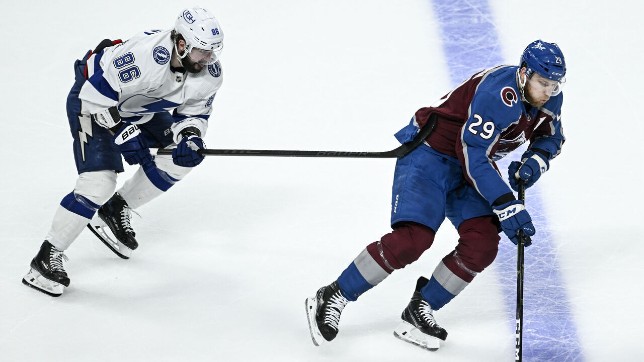 DENVER, CO - JUNE 24: Nathan MacKinnon (29) of the Colorado Avalanche handles the puck as Nikita Kucherov (86) of the Tampa Bay Lightning defends during the second period at Ball Arena in Denver on Friday, June 24, 2022. The Colorado Avalanche versus the Tampa Bay Lightning for game five of the Stanley Cup Finals led 3-1 by Colorado.