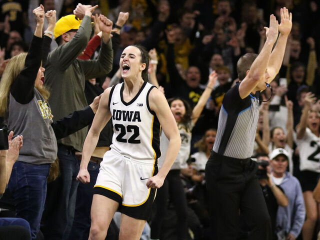 IOWA CITY, IOWA- FEBRUARY 15: Guard Caitlin Clark #22 of the Iowa Hawkeyes celebrates after breaking the NCAA women's all-time scoring record during the first half against the Michigan Wolverines at Carver-Hawkeye Arena on February 15, 2024 in Iowa City, Iowa.