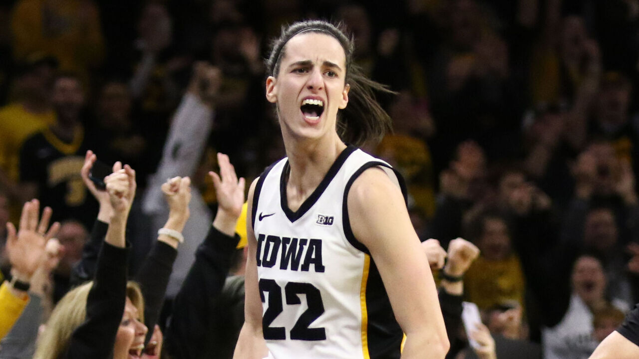 IOWA CITY, IOWA- FEBRUARY 15: Guard Caitlin Clark #22 of the Iowa Hawkeyes celebrates after breaking the NCAA women's all-time scoring record during the first half against the Michigan Wolverines at Carver-Hawkeye Arena on February 15, 2024 in Iowa City, Iowa.