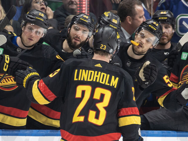 VANCOUVER, CANADA - FEBRUARY 15: Elias Lindholm #23 of the Vancouver Canucks celebrates his goal with teammates during the third period of their NHL game against the Detroit Red Wings at Rogers Arena on February 15, 2024 in Vancouver, British Columbia, Canada.