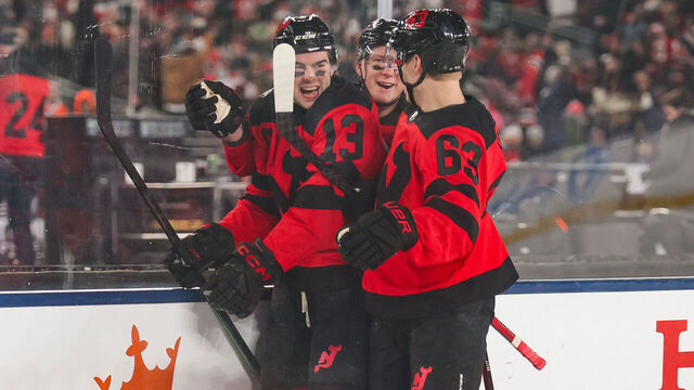 EAST RUTHERFORD, NJ - FEBRUARY 17: New Jersey Devils center Nico Hischier (13) celebrates with New Jersey Devils left wing Ondrej Palat (18) and New Jersey Devils left wing Jesper Bratt (63) after scoring a goal during a NHL Stadium Series game between the Philadelphia Flyers and New Jersey Devils on February 17, 2024 at Metlife Stadium in East Rutherford, New Jersey.