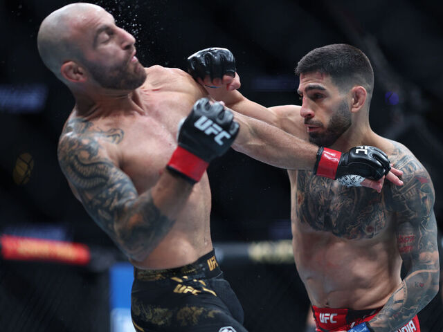 ANAHEIM, CALIFORNIA - FEBRUARY 17: Alexander Volkanovski of Australia exchanges strikes with Ilia Topuria in their featherweight title fight during UFC 298 at Honda Center on February 17, 2024 in Anaheim, California.