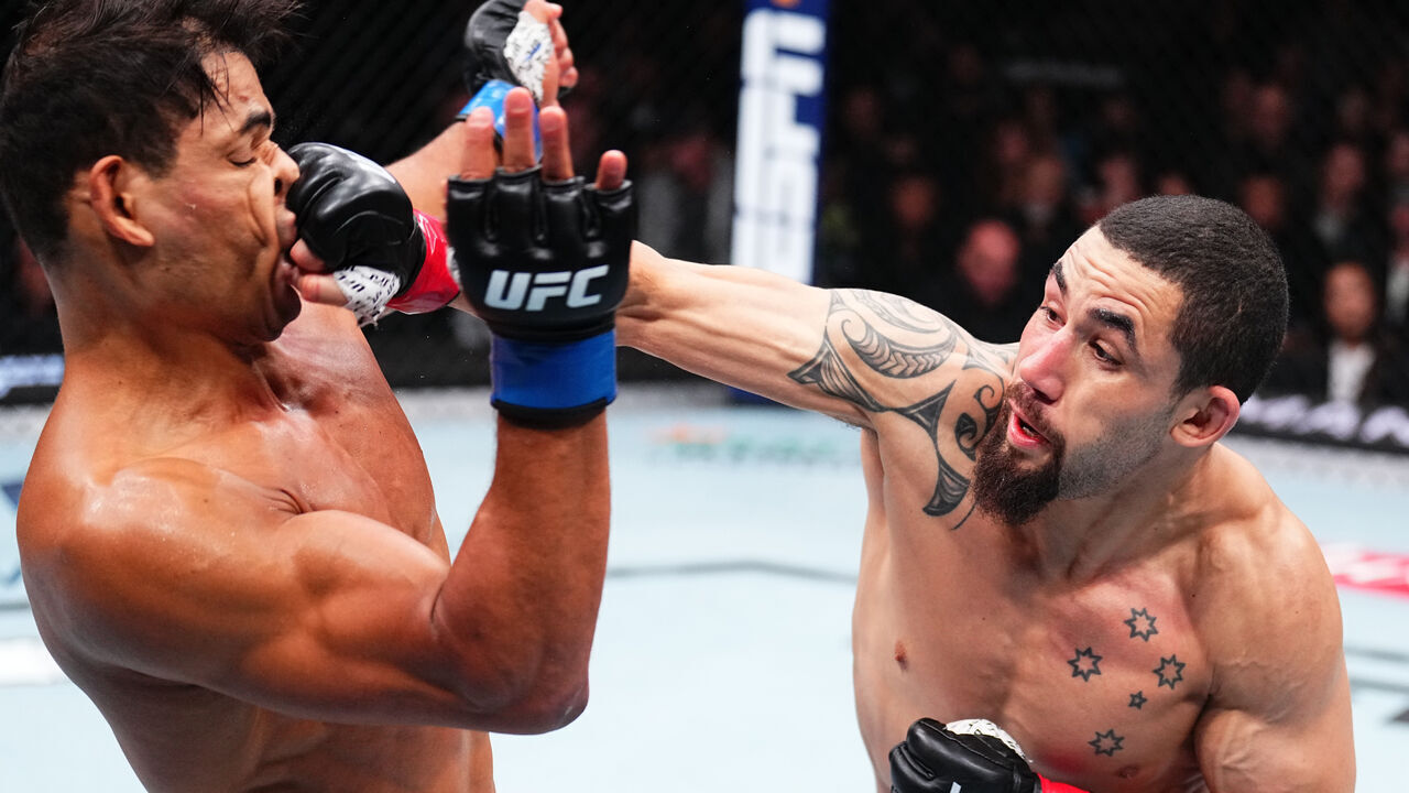 ANAHEIM, CALIFORNIA - FEBRUARY 17: (R-L) Robert Whittaker of New Zealand punches Paulo Costa of Brazil in a middleweight fight during the UFC 298 event at Honda Center on February 17, 2024 in Anaheim, California.