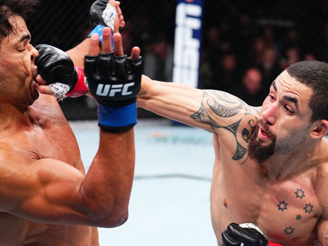 ANAHEIM, CALIFORNIA - FEBRUARY 17: (R-L) Robert Whittaker of New Zealand punches Paulo Costa of Brazil in a middleweight fight during the UFC 298 event at Honda Center on February 17, 2024 in Anaheim, California.
