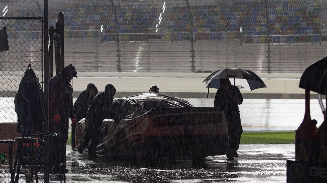 DAYTONA, FL - FEBRUARY 16: Crew members push the car of Brad Keselowski, driver of the #2 Team Penske Discount Tire Ford Mustang, after rain postponed the Daytona 500 on February 16, 2020 at Daytona International Speedway in Daytona Beach, Fl.