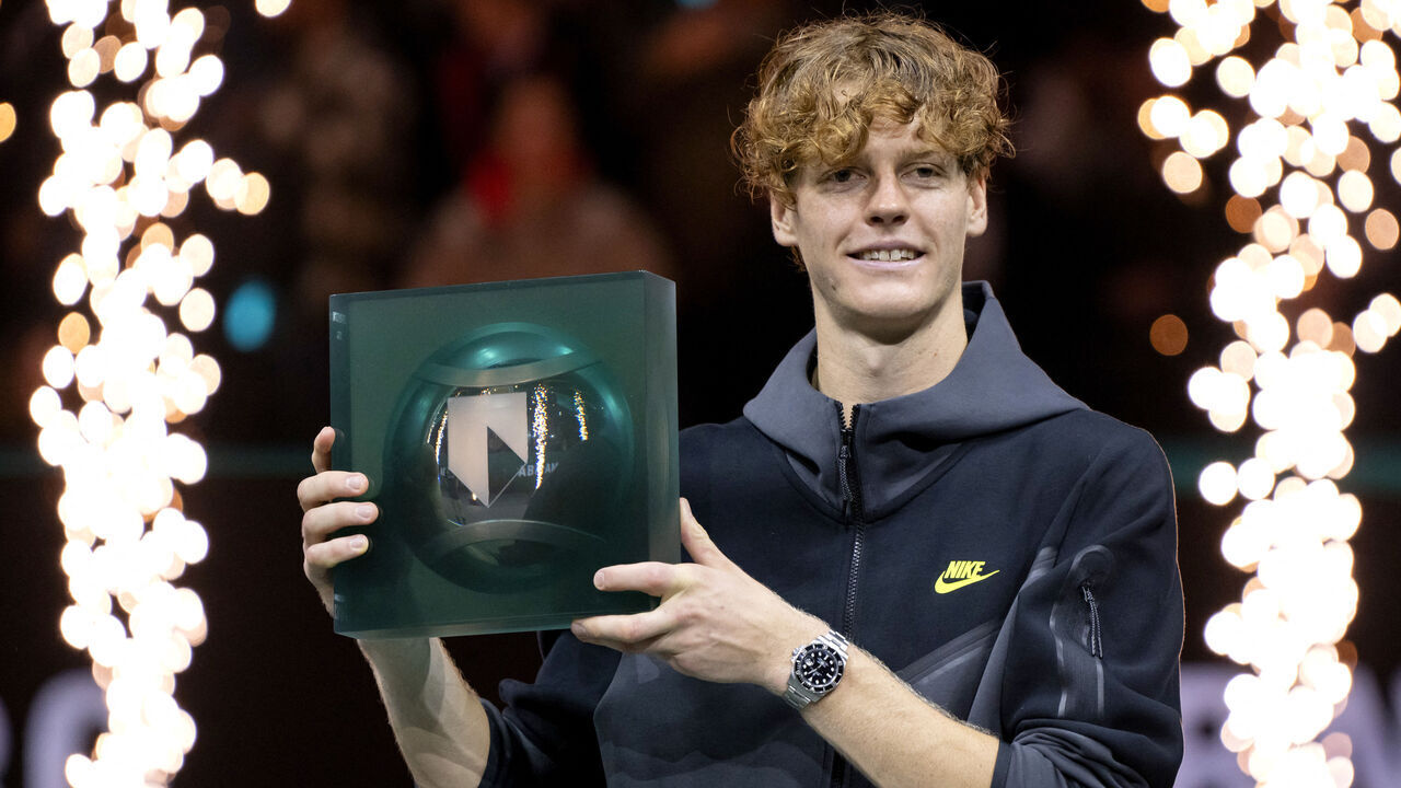 Italy's Jannik Sinner poses with the trophy after beating Australia's Alex de Minaur in the men's singles ABN AMRO Rotterdam Open tennis tournament in Ahoy, Rotterdam on February 18, 2024. Italy's Jannik Sinner powered to his first Rotterdam Open title on February 18, 2024, breaking down a determined defensive effort from Australia's Alex De Minaur to win 7-5, 6-4 in a high-quality battle.