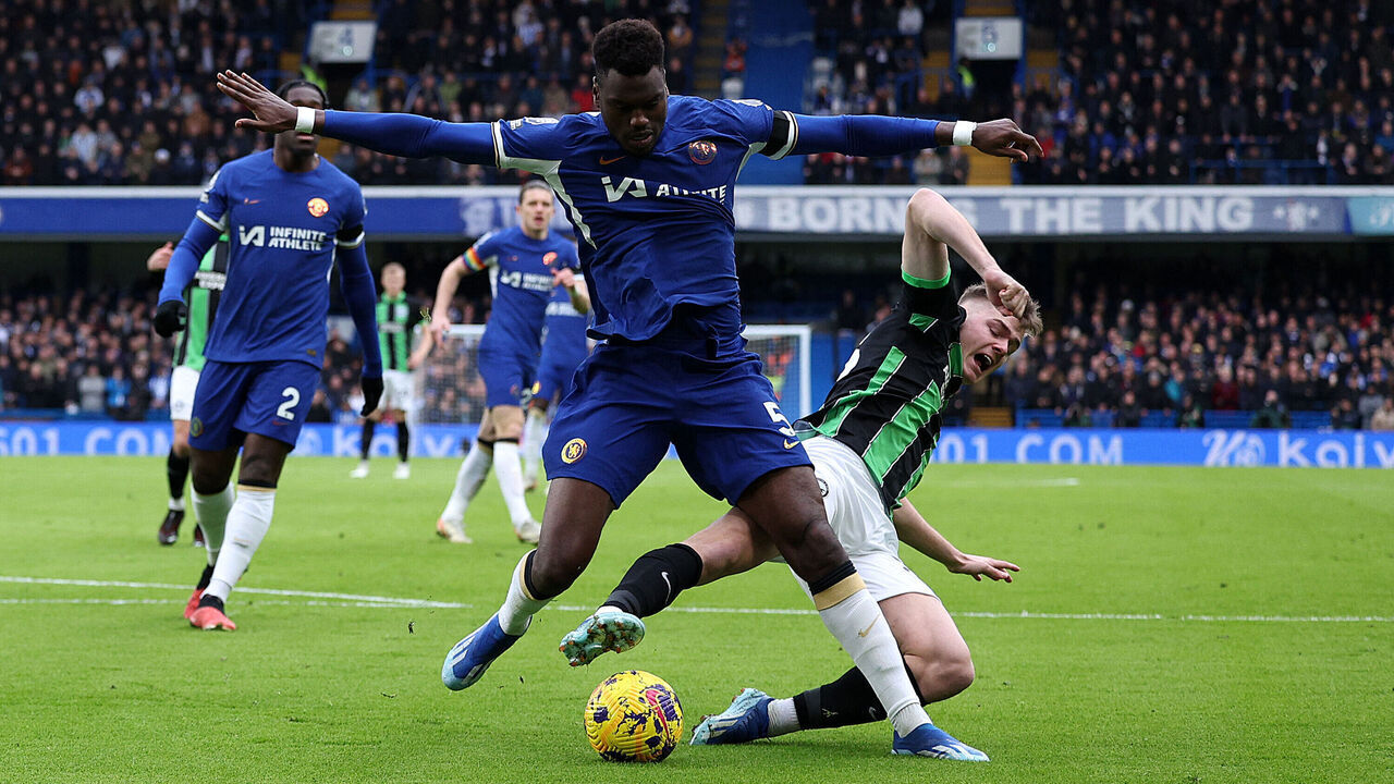 Chelsea's French defender #05 Benoit Badiashile challenges Brighton's Irish striker #28 Evan Ferguson during the English Premier League football match between Chelsea and Brighton and Hove Albion at Stamford Bridge in London on December 3, 2023.