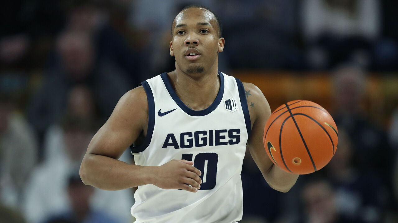 LOGAN, UT - JANUARY 20 : Darius Brown II #10 of the Utah State Aggies brings the ball up the court against the Fresno State Bulldogs during the first half of their game at Dee Glen Smith Spectrum the on January 20, 2024 in Logan, Utah.