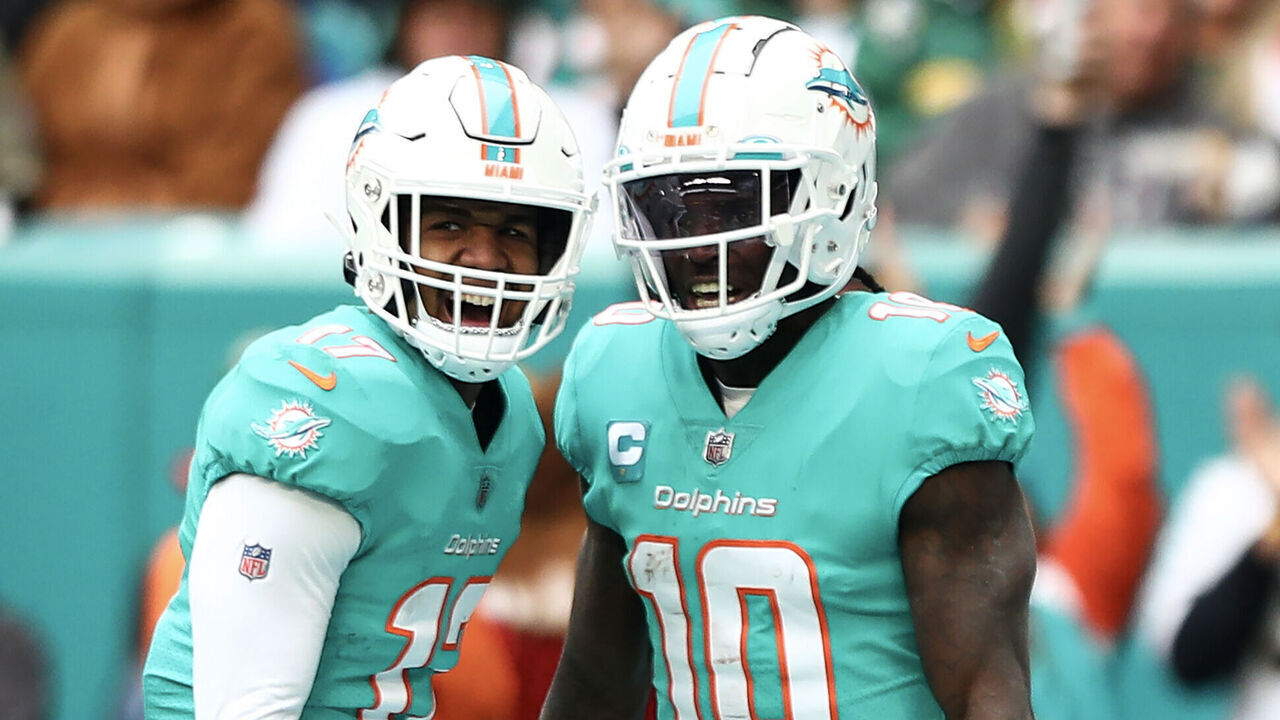 MIAMI GARDENS, FL - DECEMBER 25: Tyreek Hill #10 of the Miami Dolphins celebrates with Jaylen Waddle #17 during the second quarter of an NFL football game against the Green Bay Packers, Sunday at Hard Rock Stadium on December 25, 2023 in Miami Gardens, Florida.